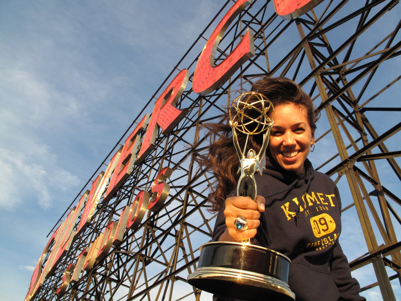 Yvonne Mojica holding an Emmy statuette on the roof of Silvercup Studios