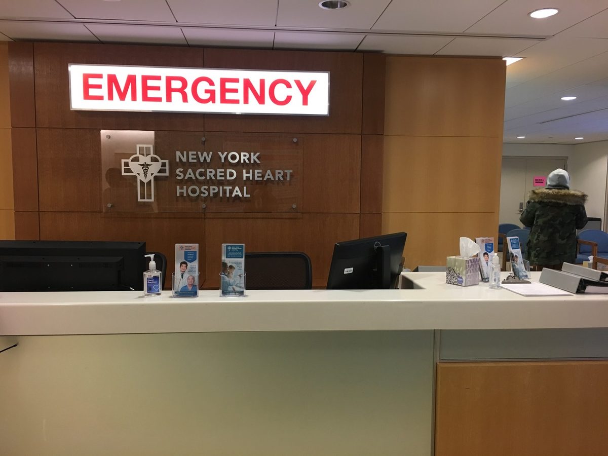 A photoshop mockup of a light-up Emergency sign on a photo of the set, to show the post-production team where to add it while editing.