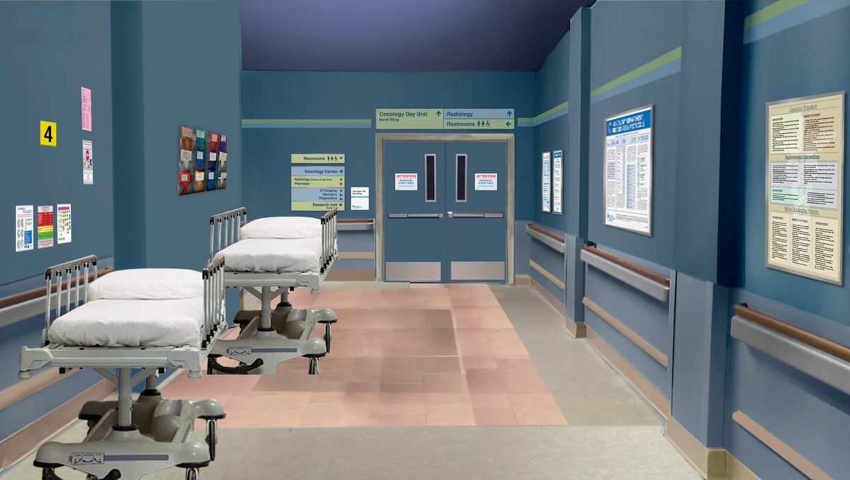 The same treatment for a ward corridor — wayfinding, notices and staff boards all placed before the walls were painted.