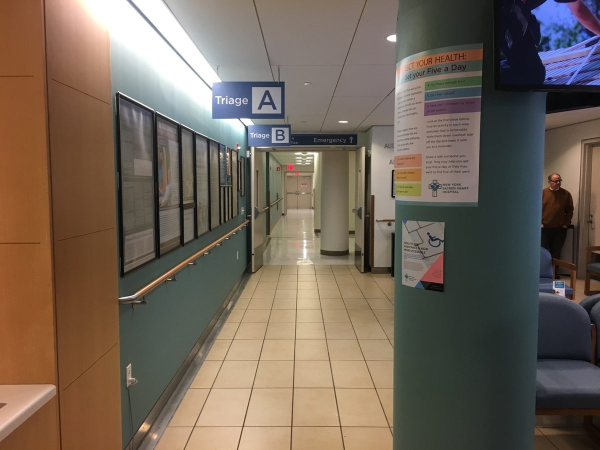Hung signage doing the wayfinding an audience reads without noticing it is reading.